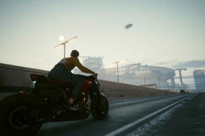 V rides a motorcycle through Night City in Cyberpunk 2077